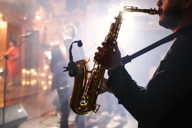 Man plays on a saxophone